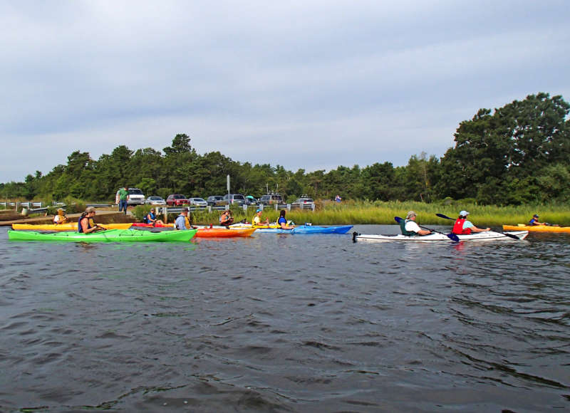 A group of kayakers in the Weweantic River at the state boat ramp.