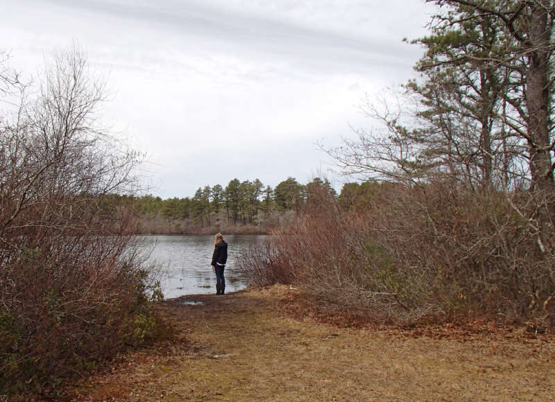 A woman standing by the Agawam Mill Pond at Whitlock's Landing in Wareham.