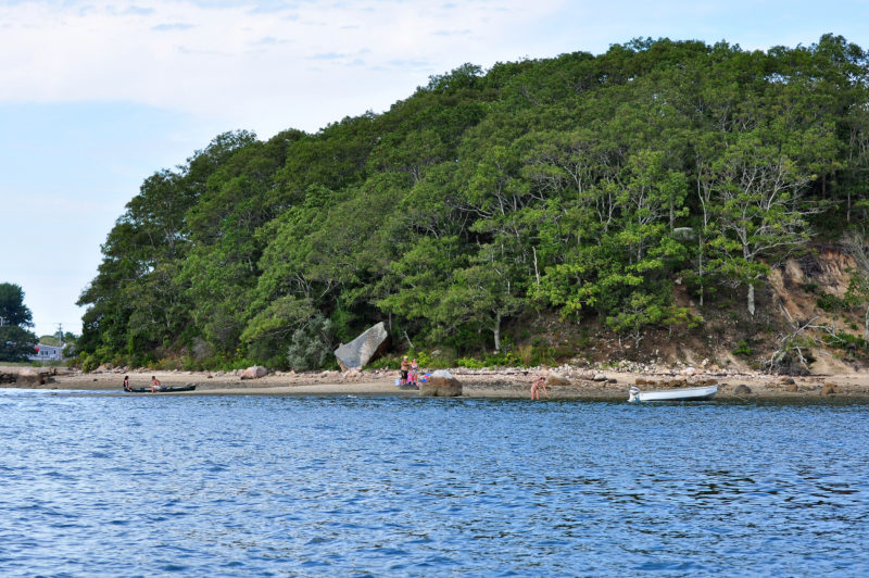 People on the shore of Wickets Island in Onset Bay.