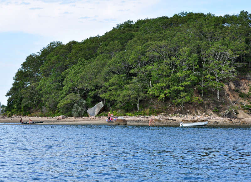 People on the shore of Wickets Island in Onset Bay.