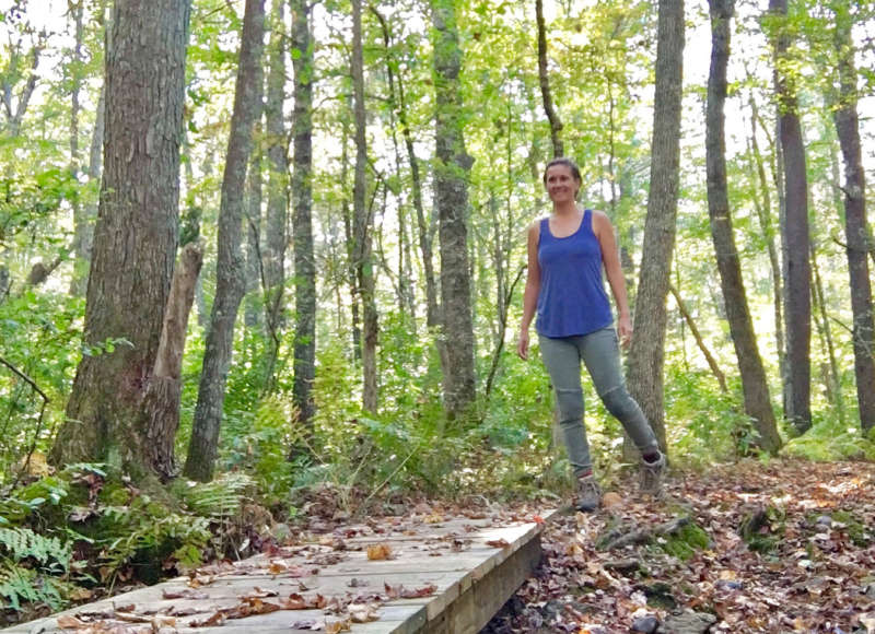 A woman walking on the trail at Lionberger Woods in Rochester.