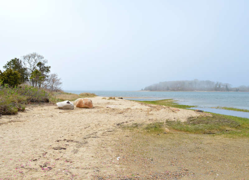 Sandy shoreline of Little Bay at Monks Park in Bourne