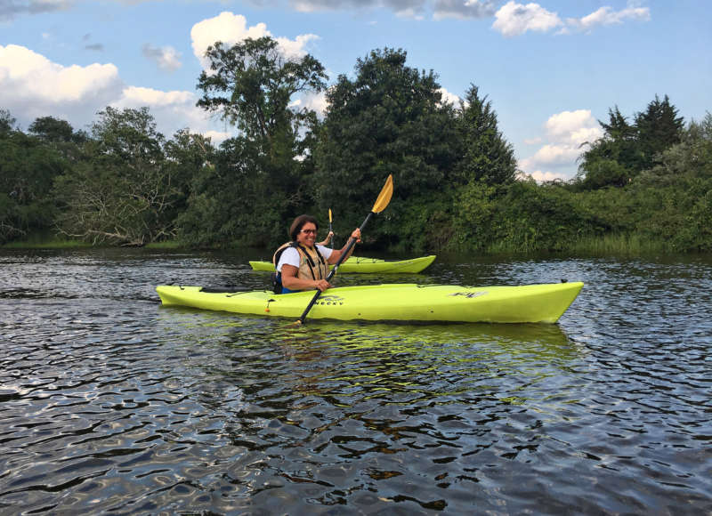 A woman kayaking on the Westport River.