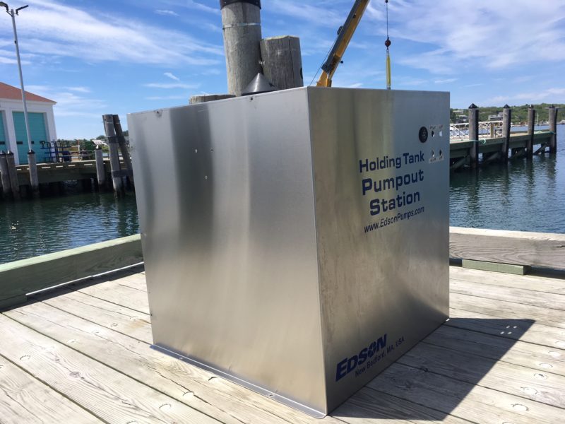 A large silver metal box labeled to show it is the new holding tank for Cuttyhunk's new boat pumpout station.