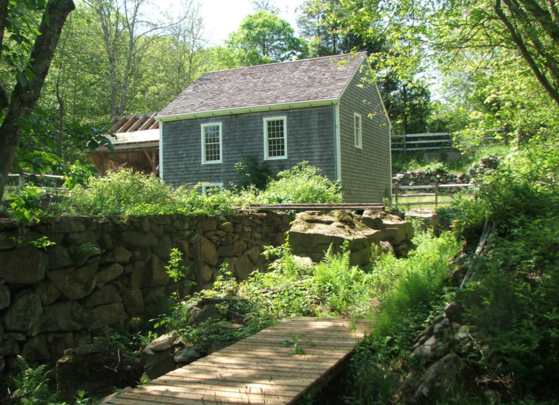 Old mill building in front of stone channel