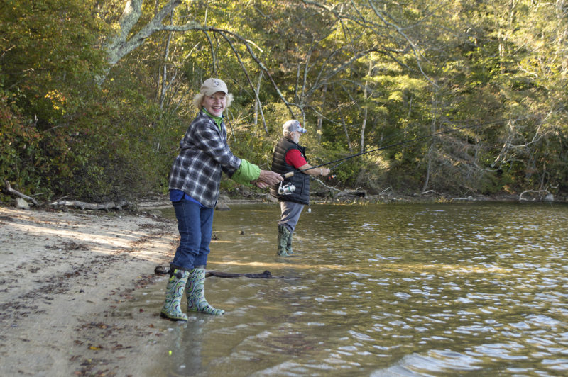 Two people fishing in the waters of Grews Pond at Goodwill Park in Falmouth