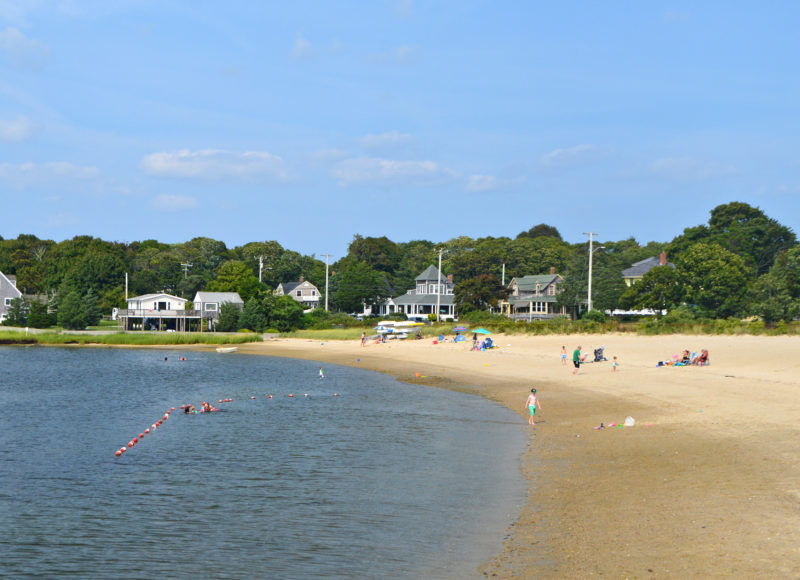 Kids playing in the water at Monument Beach in Bourne