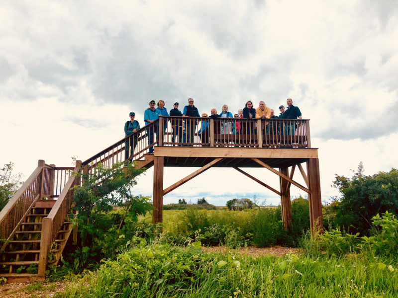 A group of people standing on the observation platform at Ocean View Farm Reserve in Dartmouth.