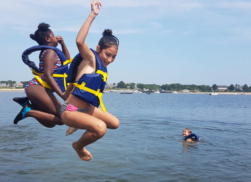 Kids jumping in the waters of Onset Bay