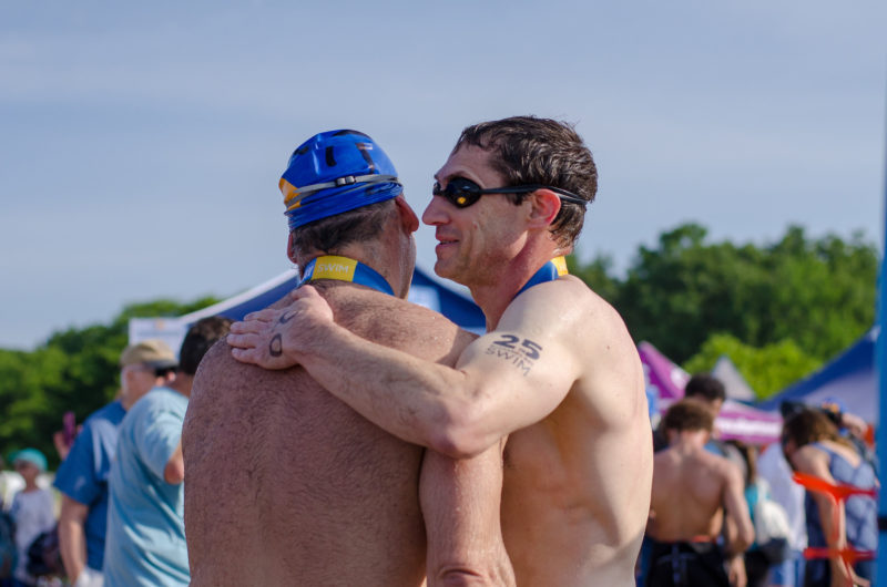 Swimmers hugging after the 2018 Swim