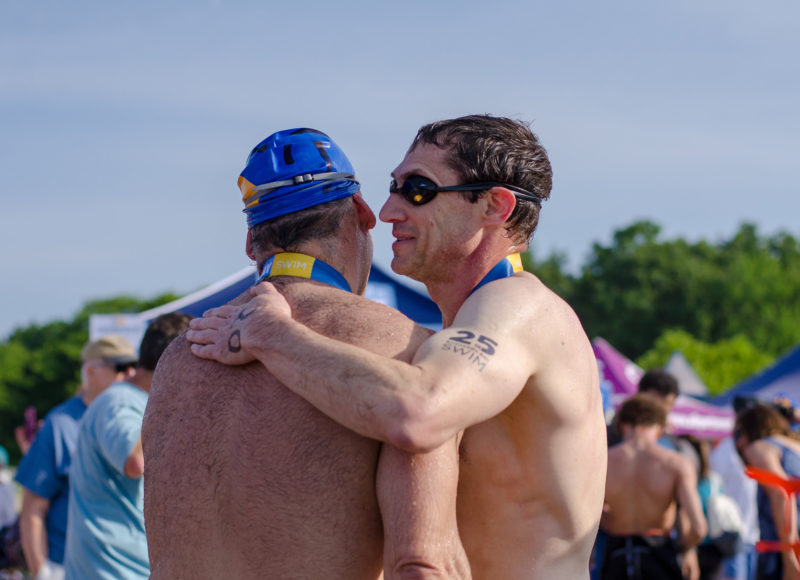 Swimmers hugging after the 2018 Swim