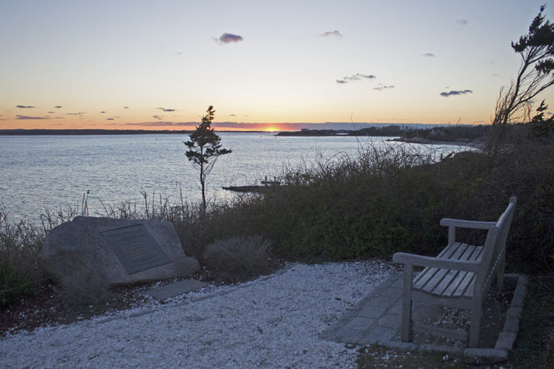 A bench on Nobska Point overlooking Vineyard Sound and the Elizabeth Islands at sunset