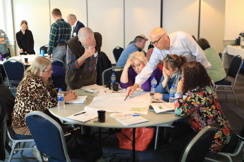 People in discussion around a table at the 2019 wetlands decision makers workshop