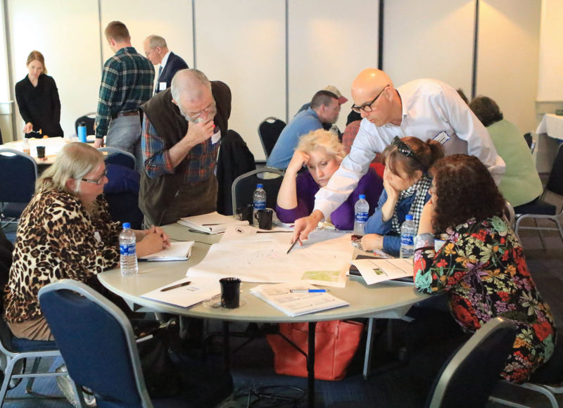 People in discussion around a table at the 2019 wetlands decision makers workshop