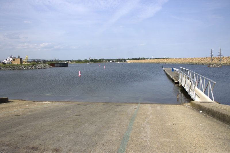 A concrete boat ramp leading into New Bedford Harbor beside the Hurricane Barrier