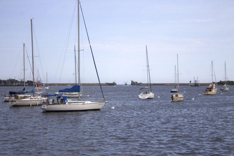 Sailboats in New Bedford Harbor with the Hurricane Barrier in the background