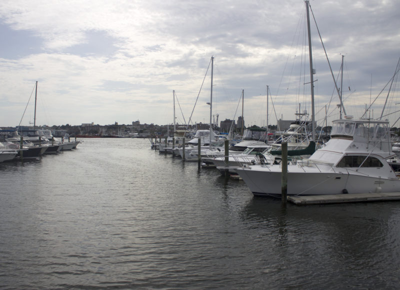 Boats in the slips at Pope's Island Marina with the city of New Bedford in the background