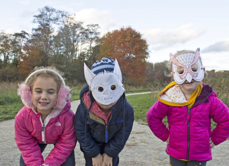 Three kids posing in Halloween masks