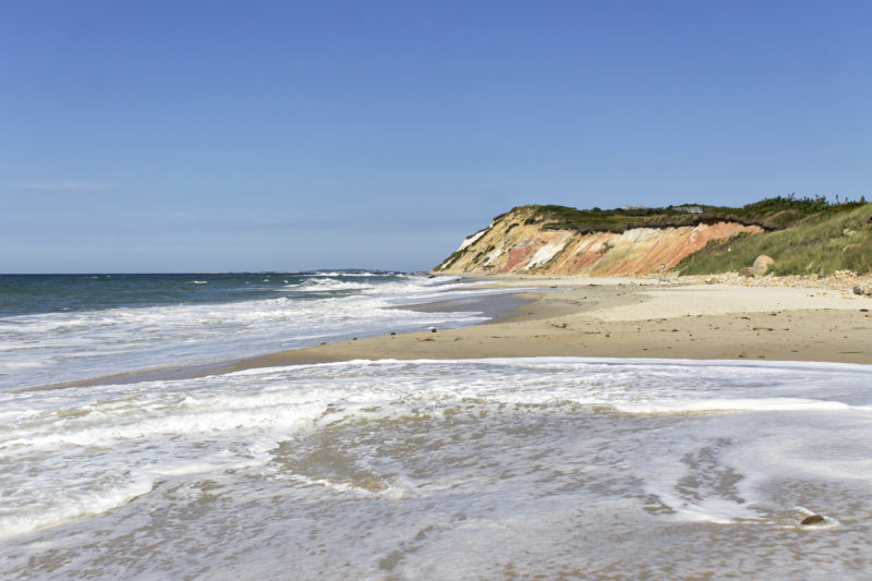 Waves washing onto the shoreline of Moshup Beach, with the Gay Head Cliffs in the background