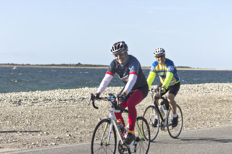 Two male riders passing Horseneck Beach during the 2019 Watershed Ride