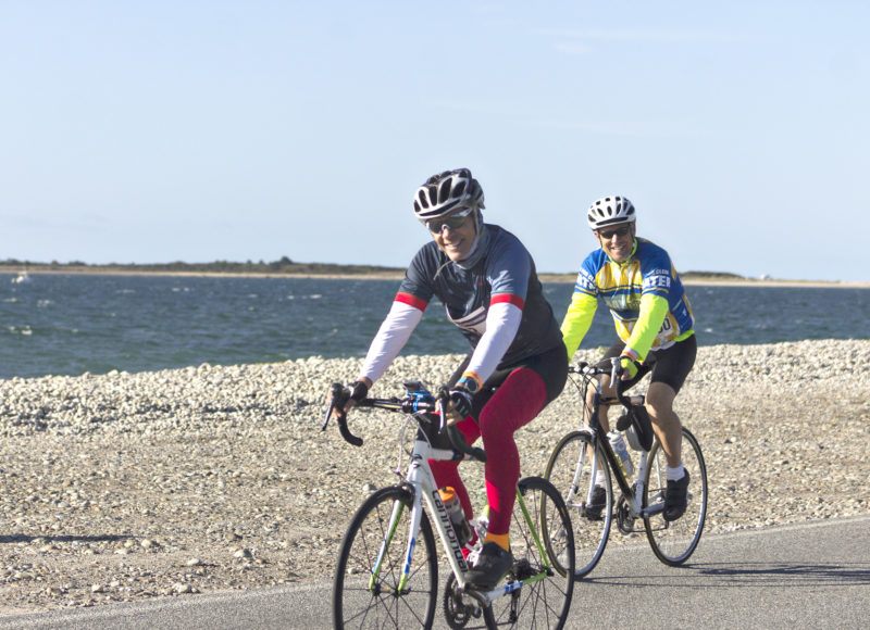 Two male riders passing Horseneck Beach during the 2019 Watershed Ride