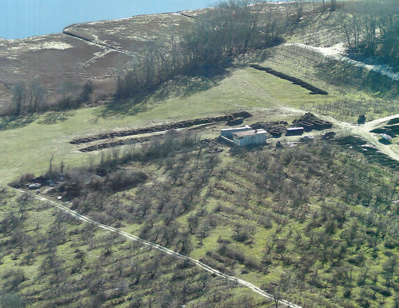 Composting materials in lines at a farm next to salt marshes