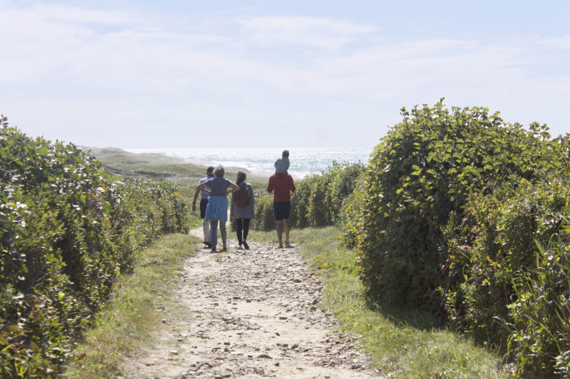 A family walking down the trails at Aquinnah Headlands Preseve