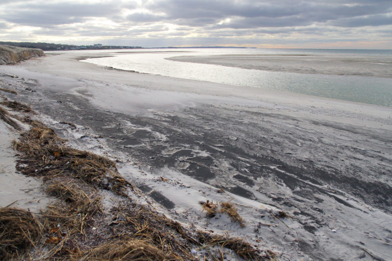 Patches of Black sand swirled into the shore of Black Beach