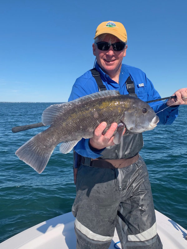 Tom Richardson holds up a black sea bass