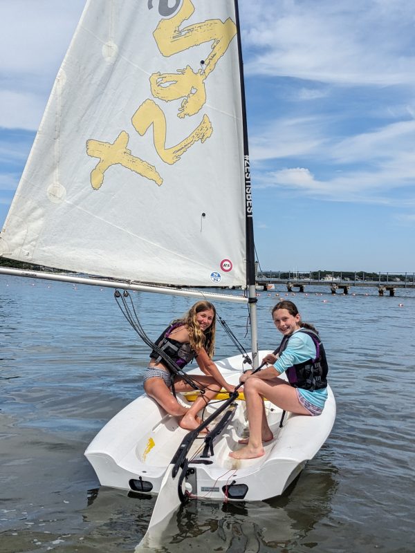 Two campers aboard a sailboat.