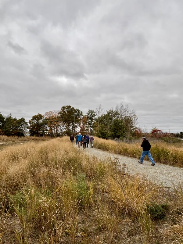 Those attending the re-opening of Marsh Island begin a walk around the property.